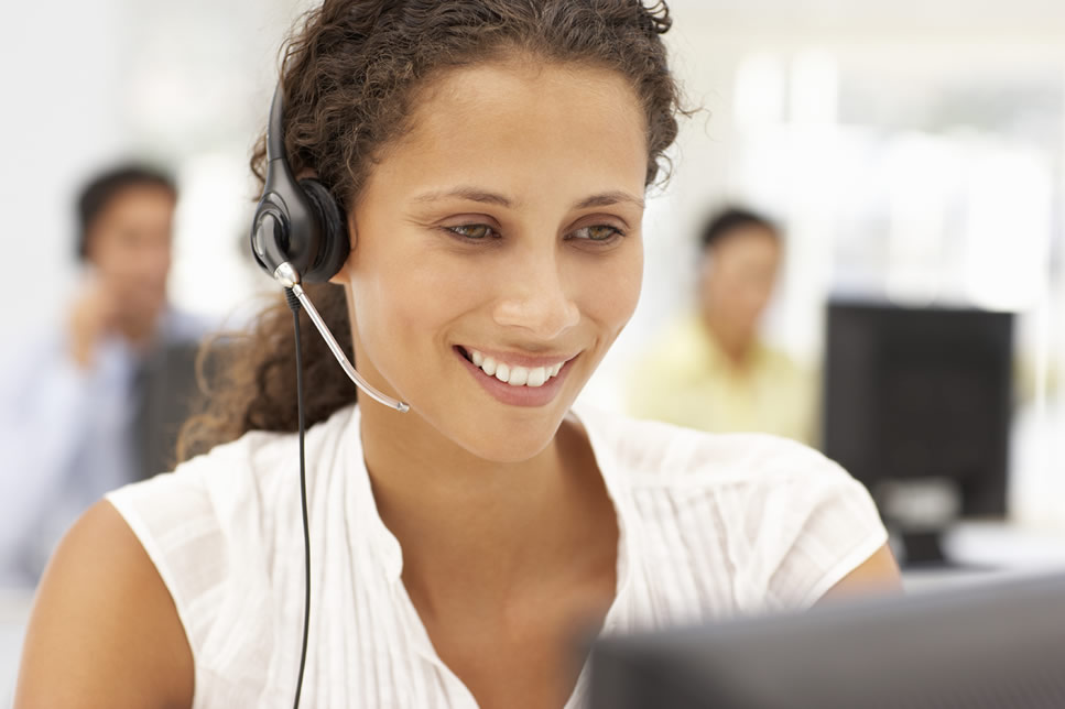 Careers at George Banco Guarantor Loans - Image is a Smiling Woman in a call centre